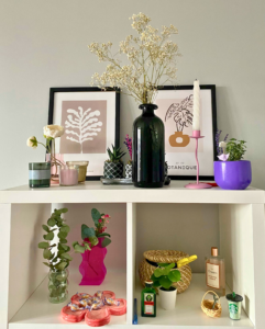 Shelves with vases, candles, frames and plants